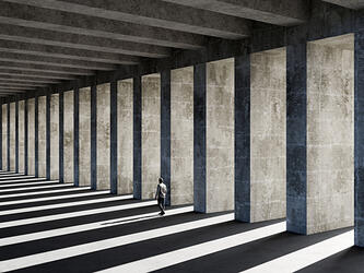 Man wlaking past concrete pillars